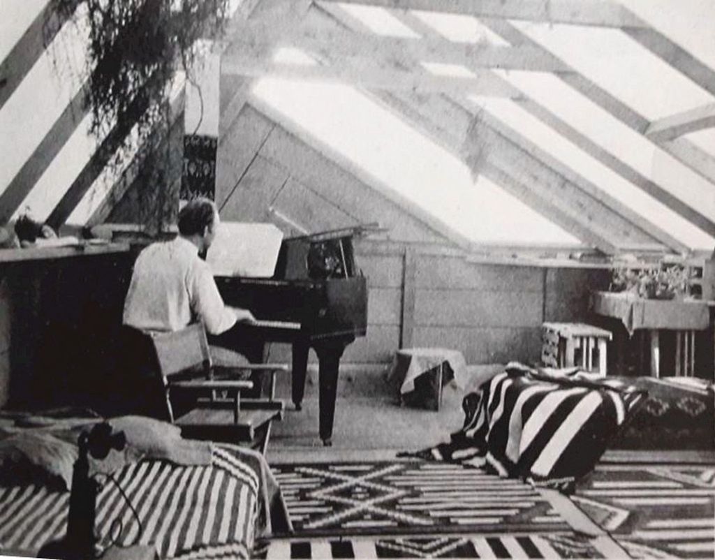This photograph taken by George Kastner in 1929 shows Lloyd Wright playing the piano in the living room of the Wright...
