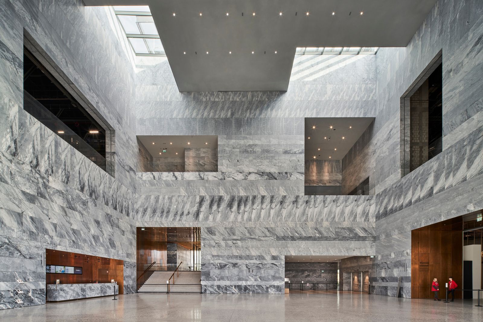 Image may contain Indoors Interior Design Architecture Building Foyer Person Floor Office Building and Shop