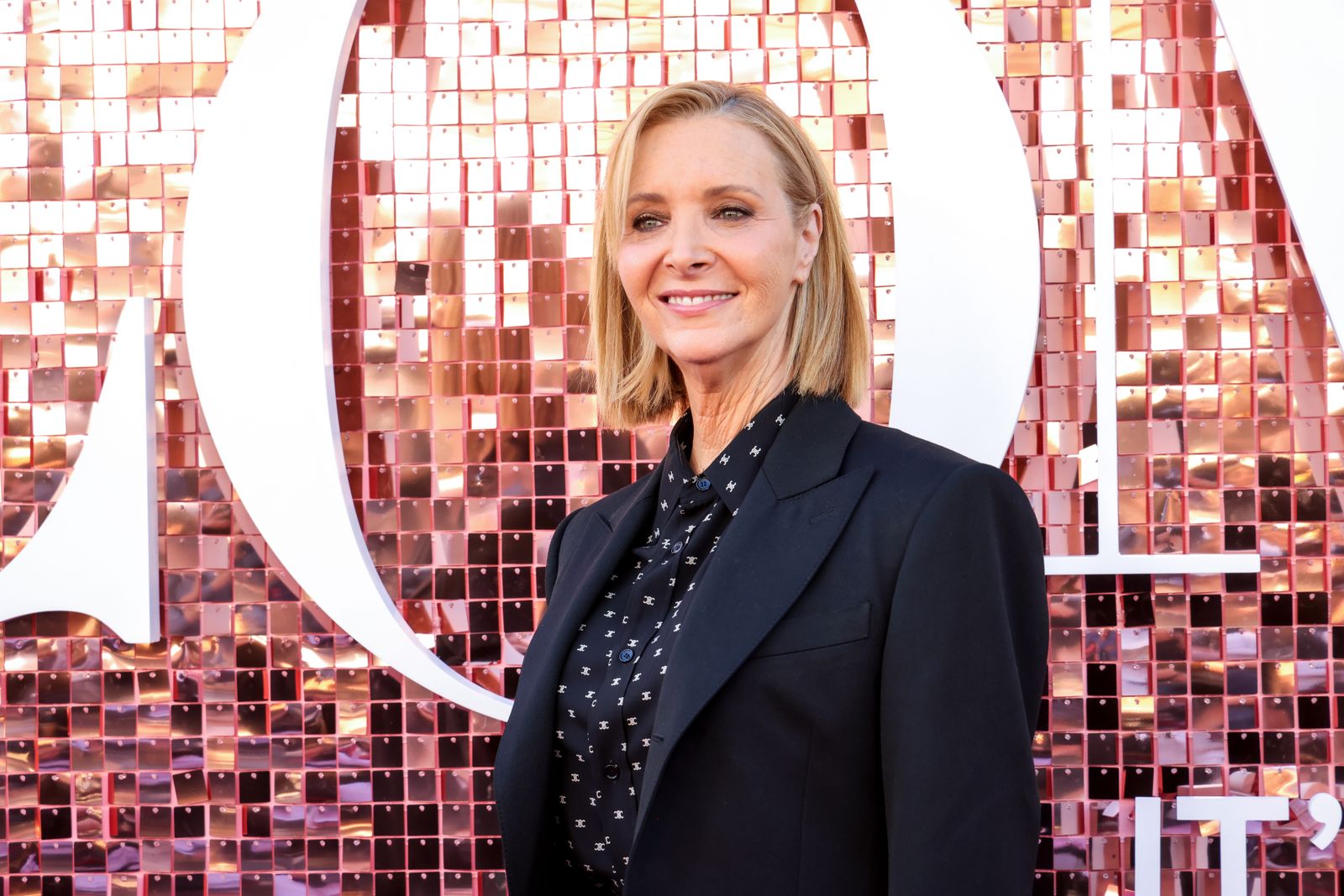Image may contain Blonde Hair Person Face Happy Head Smile Adult Blazer Clothing Coat Jacket and Photography