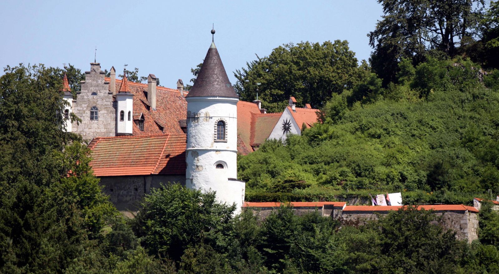 Image may contain Architecture Building Spire Tower Monastery House Housing Roof Bell Tower and Tile Roof