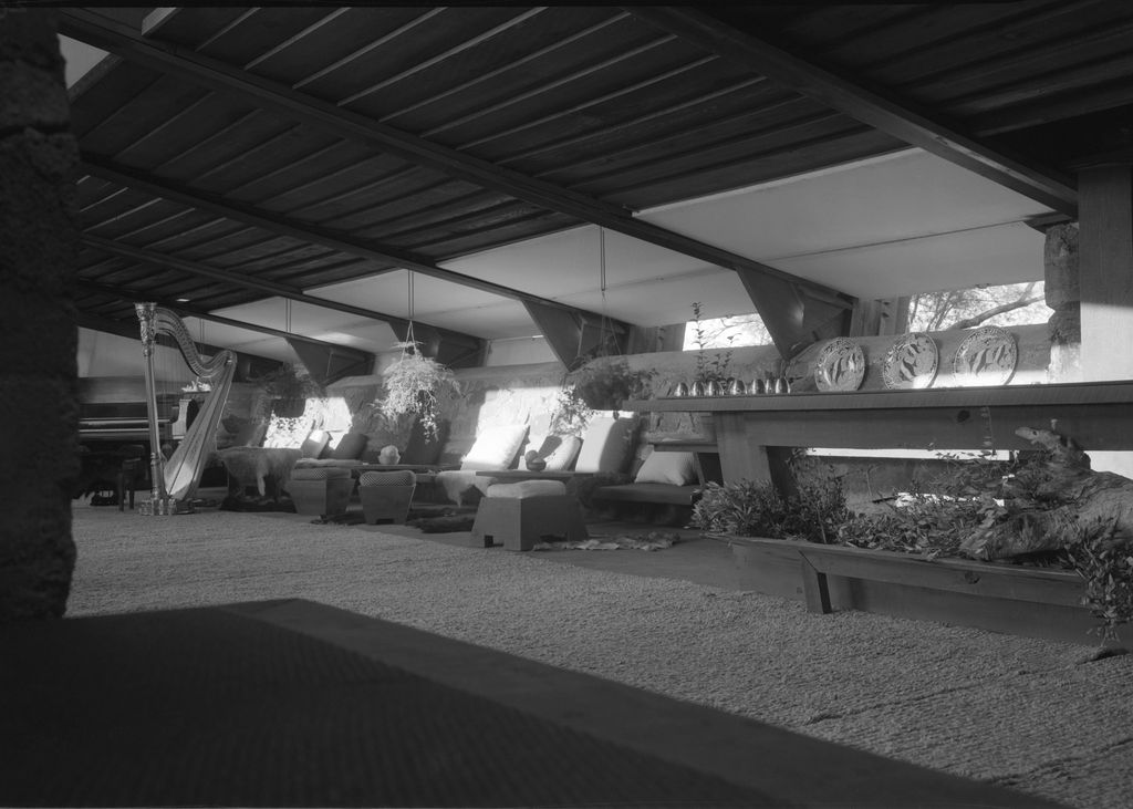 Interior view of the living room with open shutters and furniture designed for the space at Taliesin West