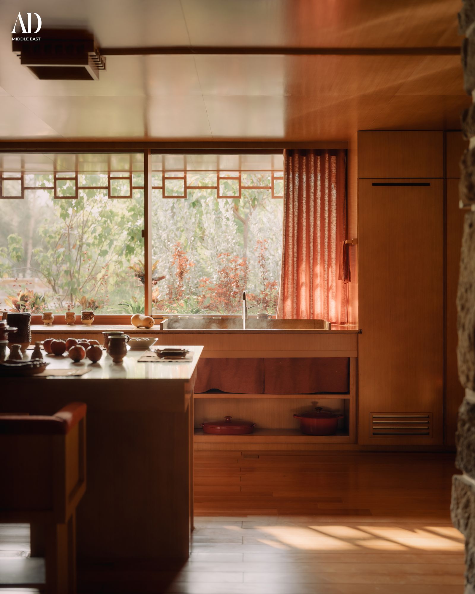 Image may contain Indoors Interior Design Kitchen Wood Chair Furniture and Kitchen Island