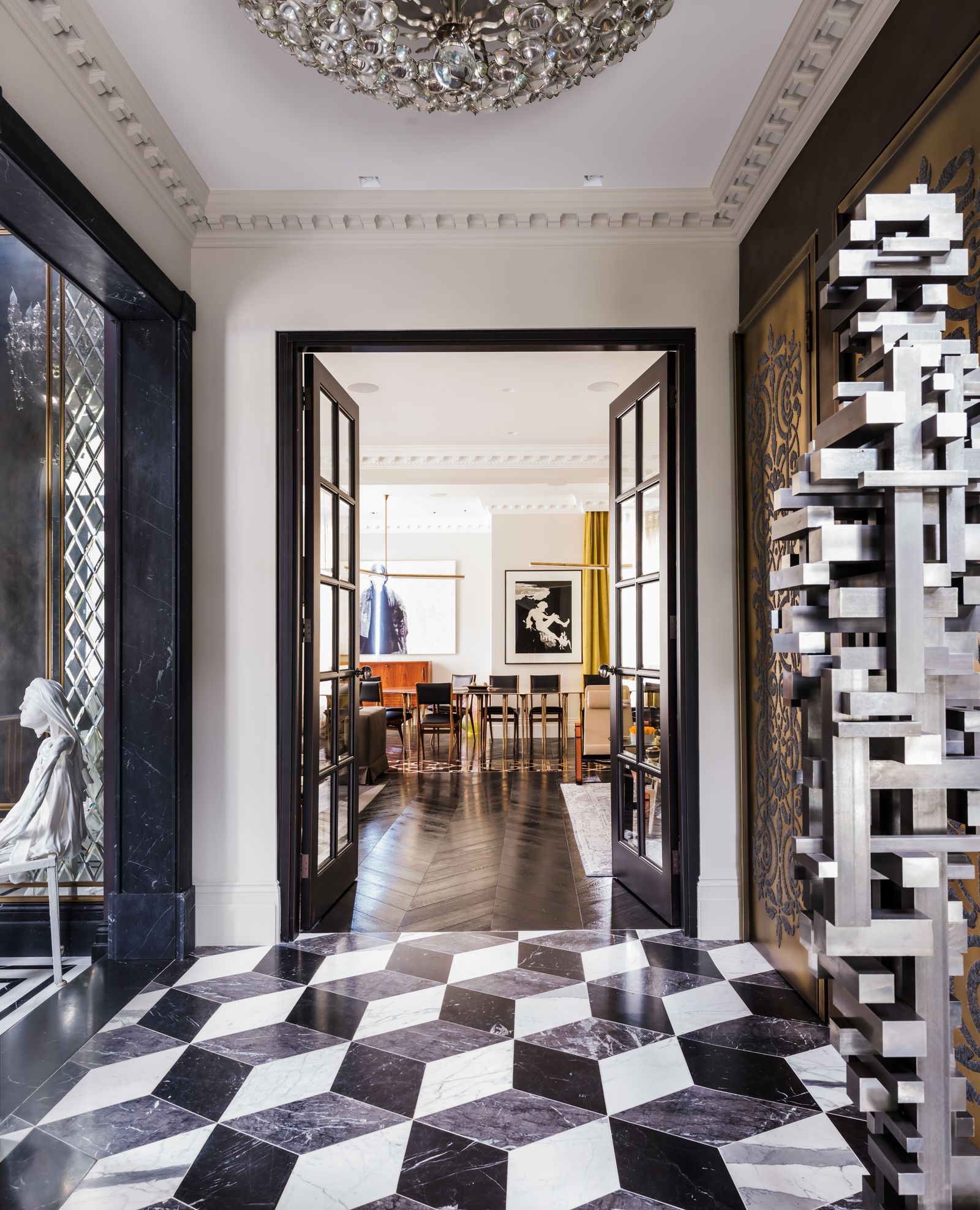 Image may contain Floor Lamp Architecture Building Foyer Indoors Door Housing and Person