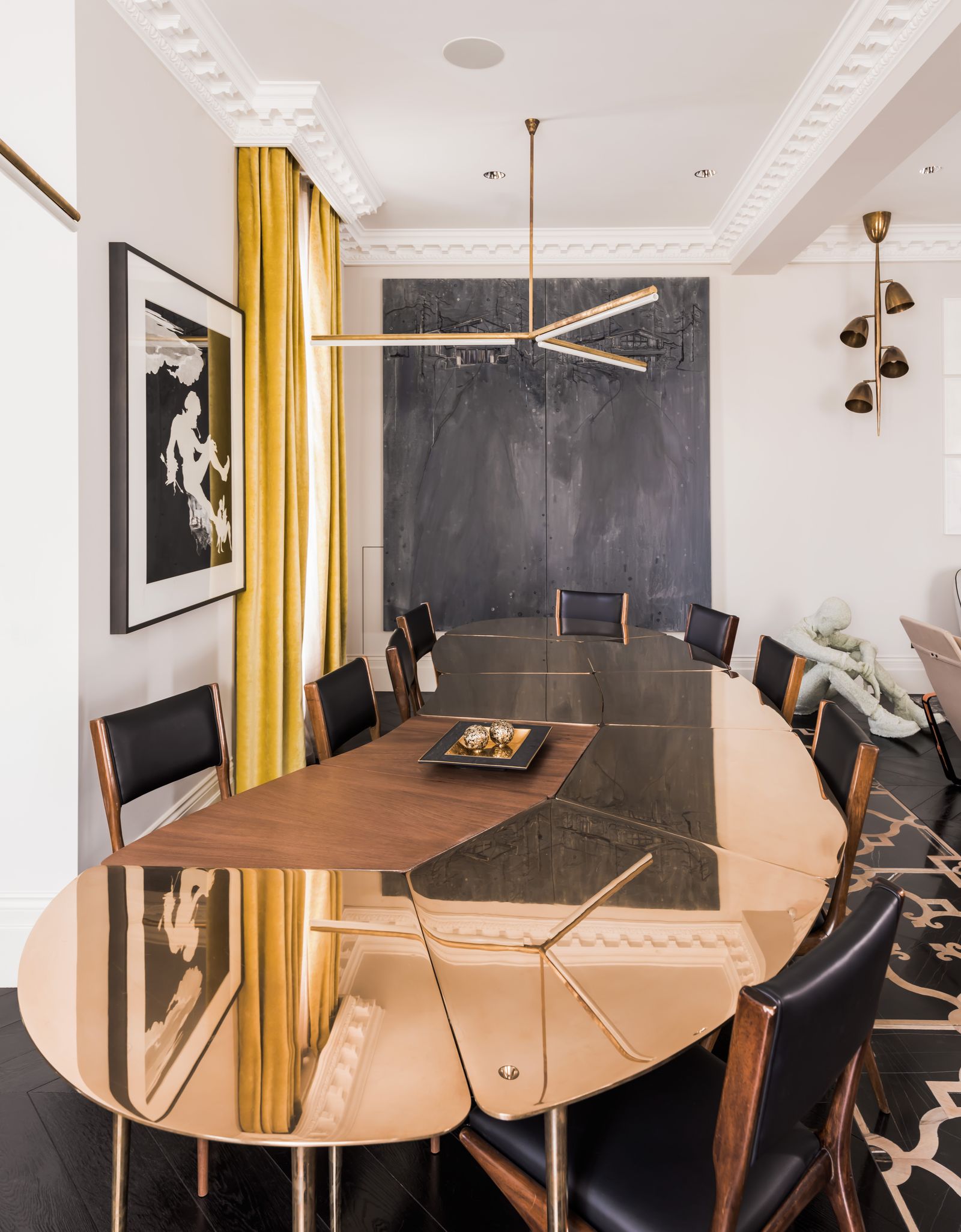 Image may contain Furniture Table Tabletop Indoors Interior Design Adult Person Chair Appliance and Ceiling Fan