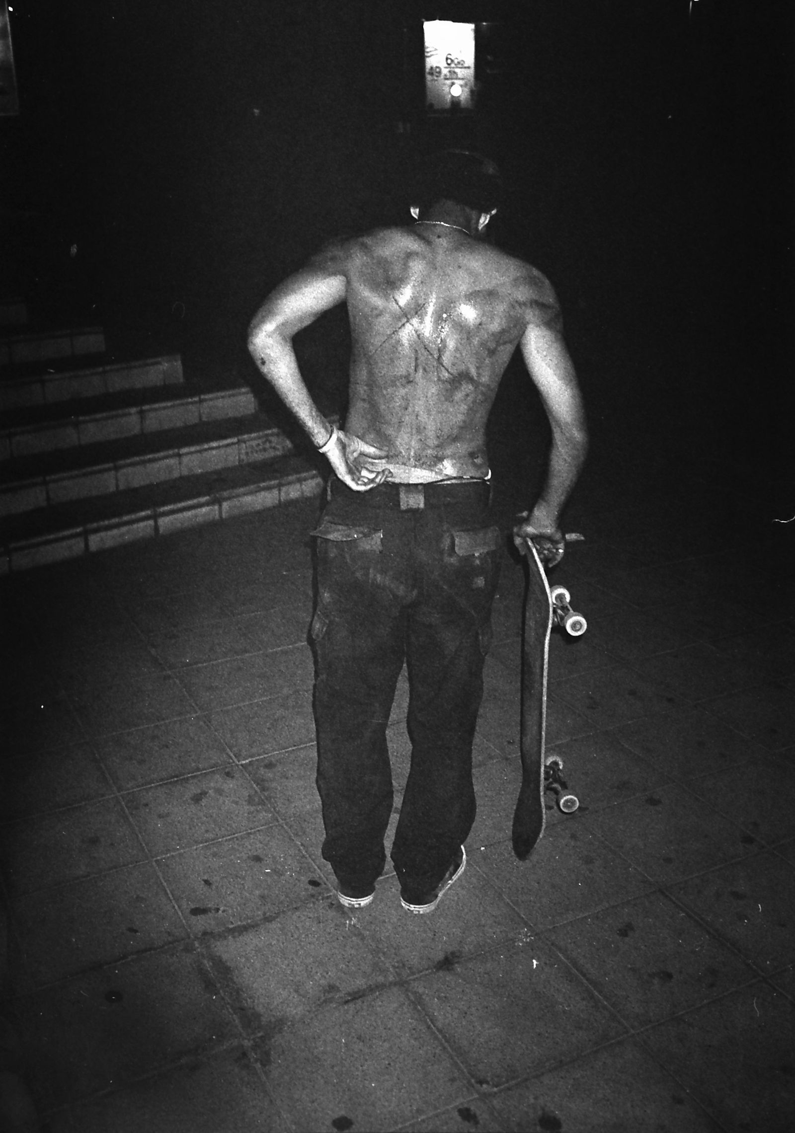 Image may contain Back Body Part Person Adult Clothing Footwear Shoe Skateboard Skin and Tattoo