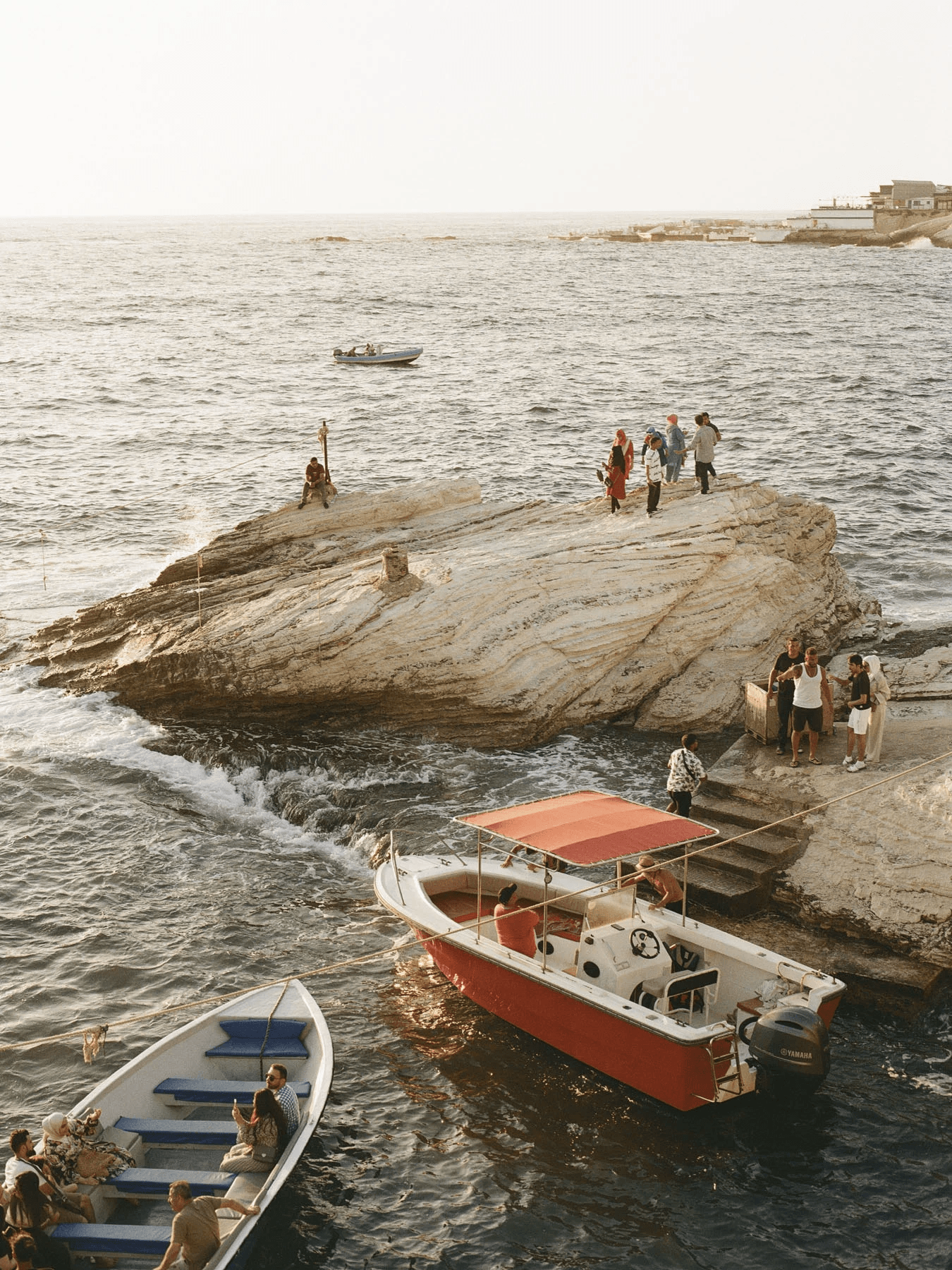 Image may contain Transportation Vehicle Yacht Watercraft Boat Back Body Part Person Rock Nature Outdoors and Sea