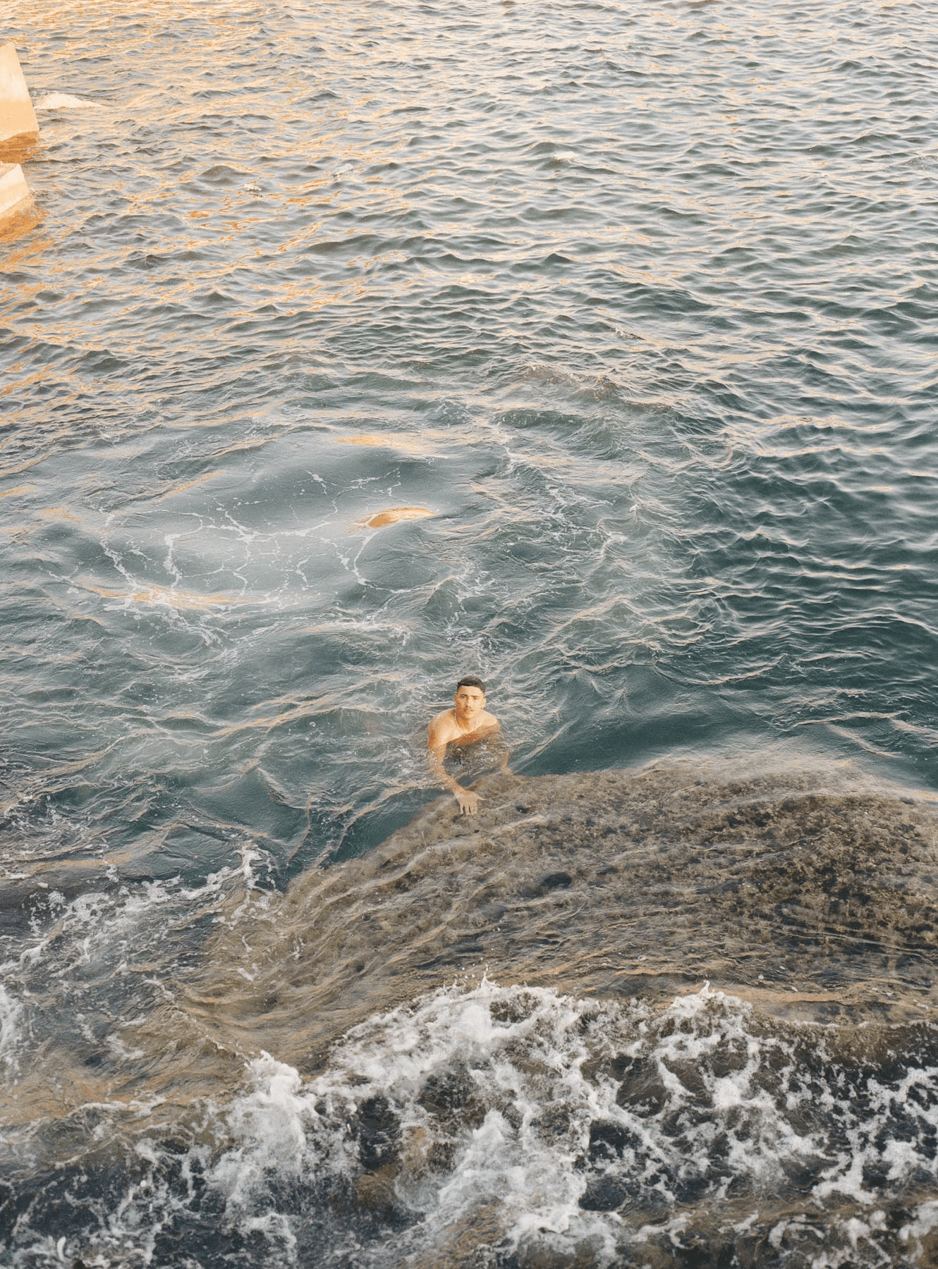 Image may contain Leisure Activities Person Sport Swimming Water Water Sports Rock Bathing Adult and Nature
